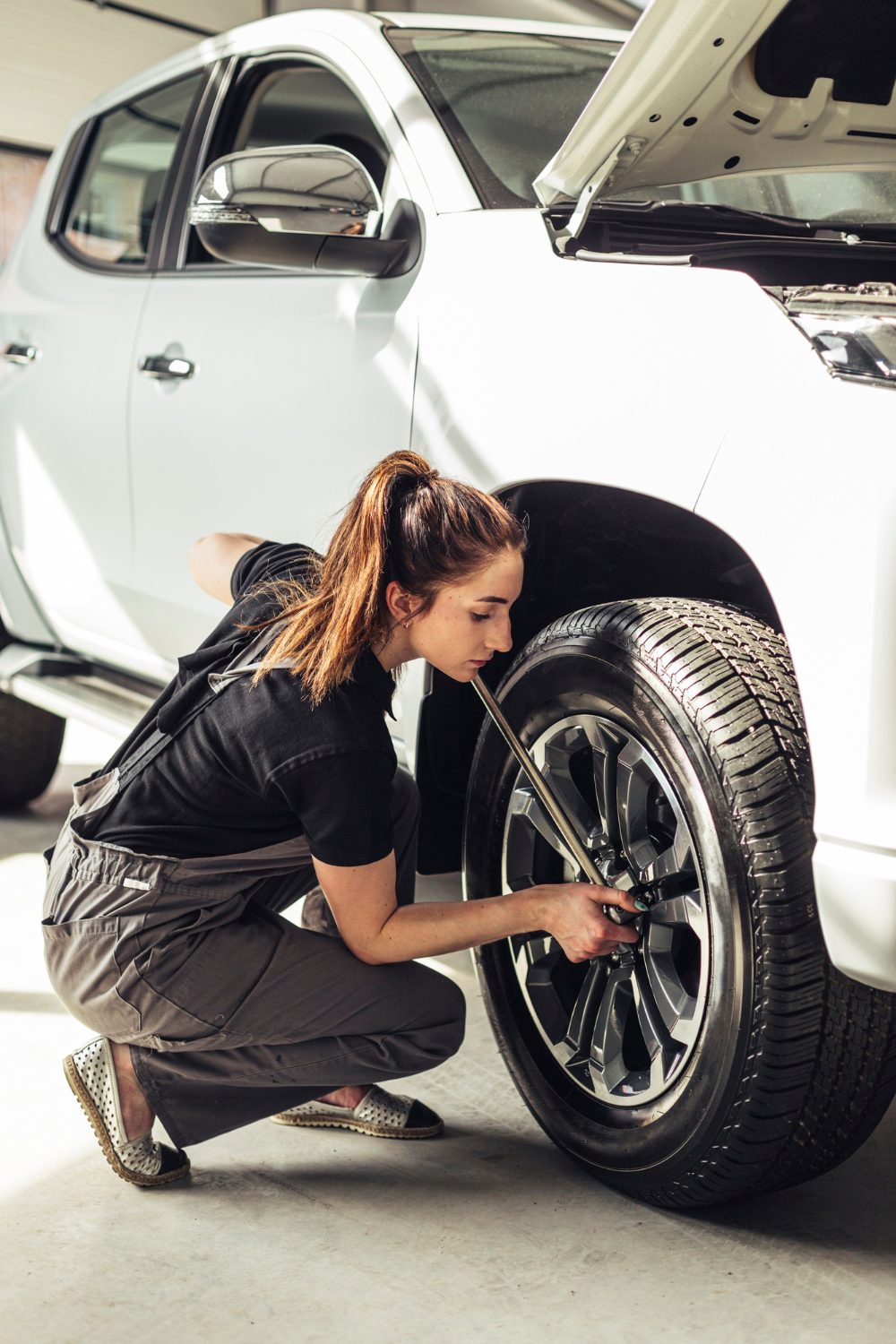 female-mechanic-fixing-car-wheels